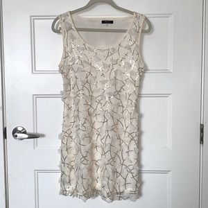 Cream dress with cream ruffled flowers and gold sequence. Size Medium.
